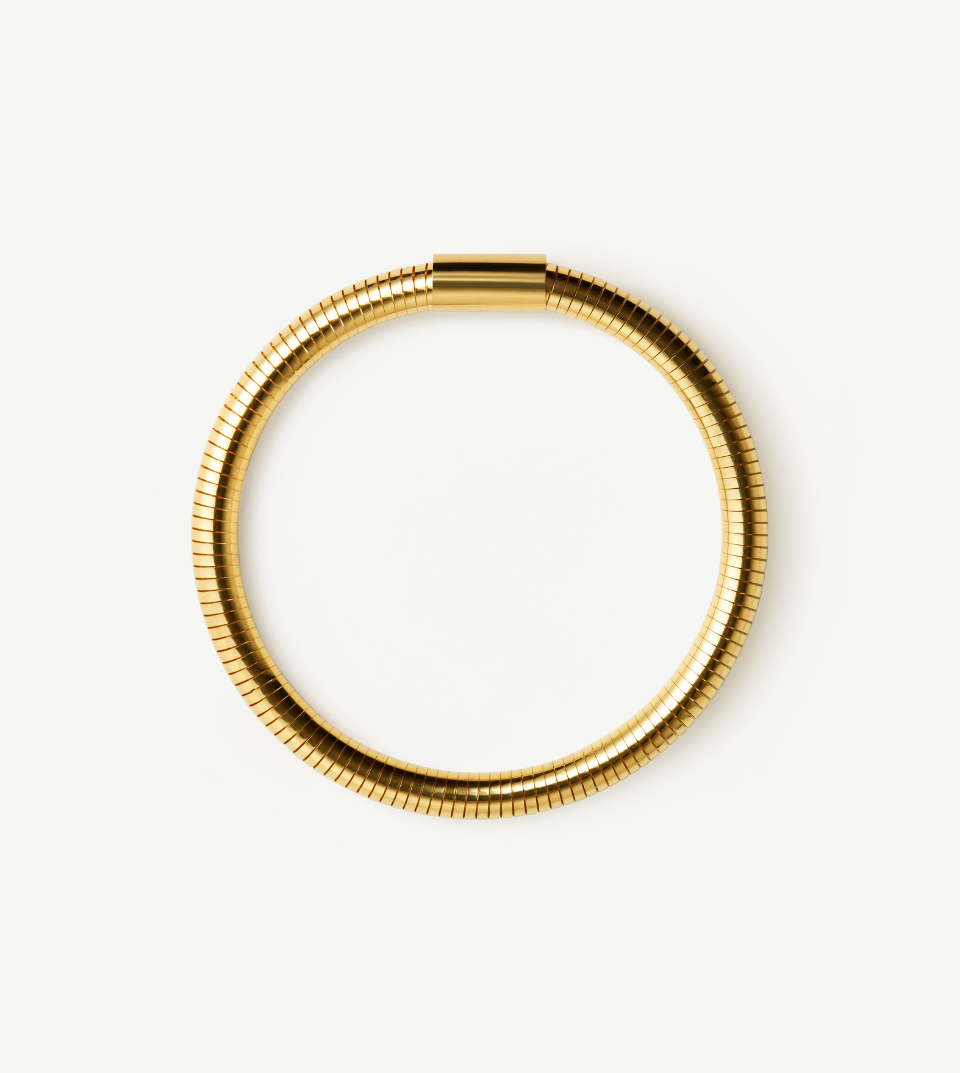 Gold FIGLIO Flex bracelet on a white background